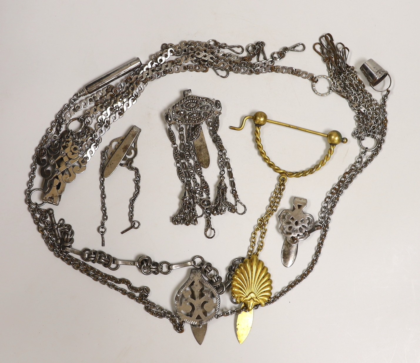 A 19th century cut steel Chatelaine, three others, a similar clasp and a later gilt metal Chatelaine and a cut steel Albert, (7)
